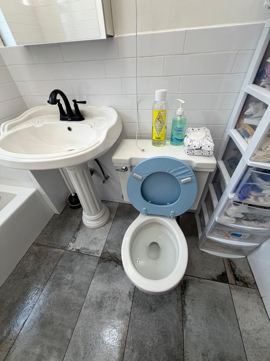 The same bathroom with a clear, mopped floor