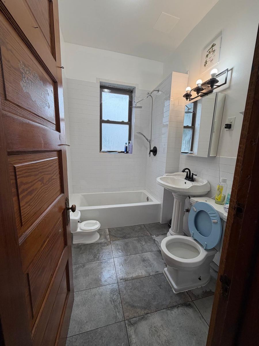 The same bathroom clean, with a mopped tile floor