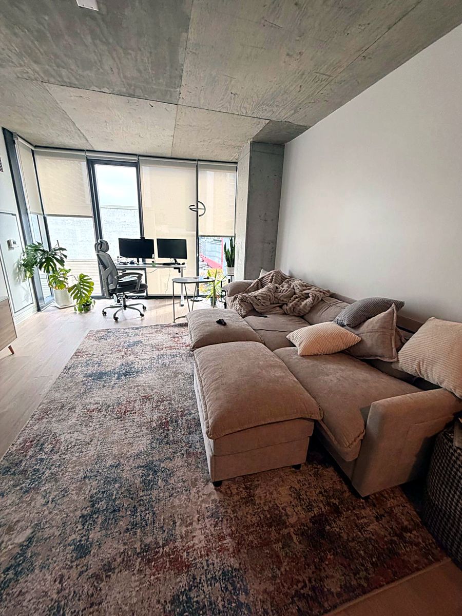 Living room with sectional sofa, rug vacuumed and floors cleaned