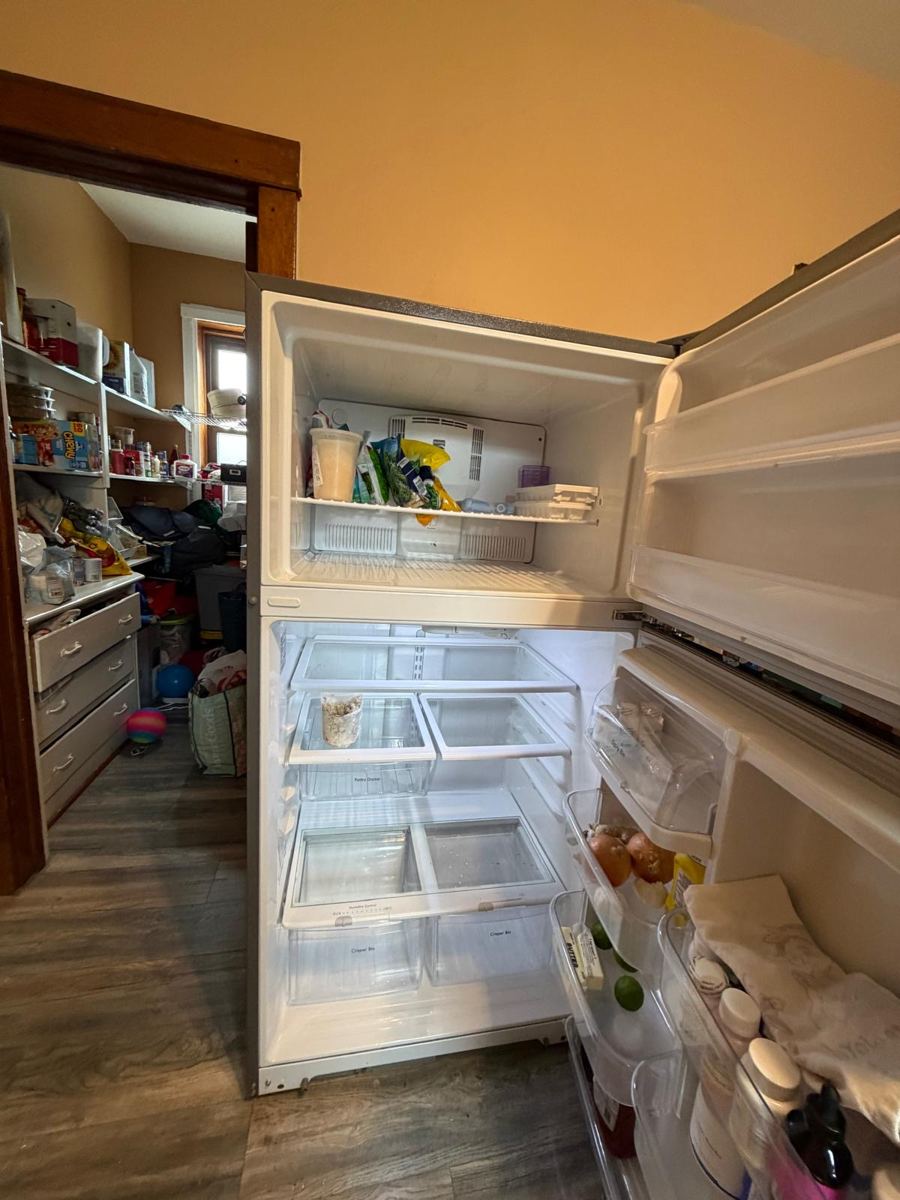 The same fridge emptied and wiped down