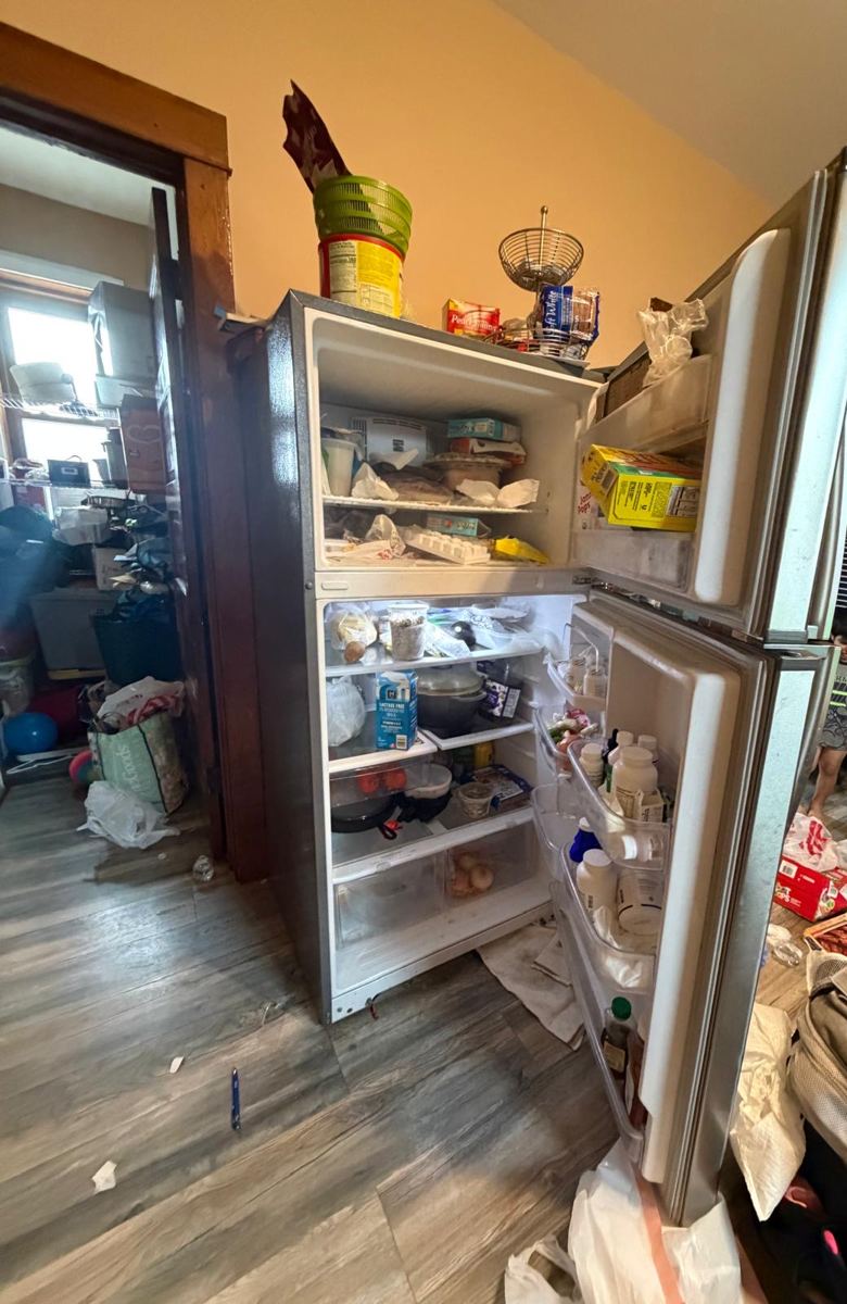 Overfilled fridge with spills on the shelves