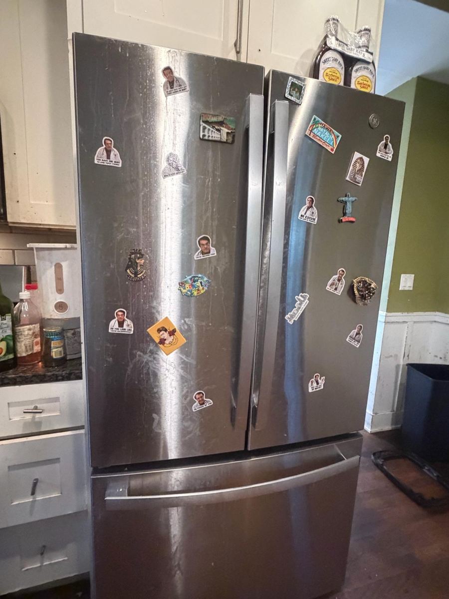 Stainless steel fridge with smudges and drip marks