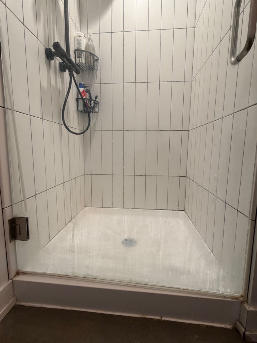 Shower floor coated in hard-water film