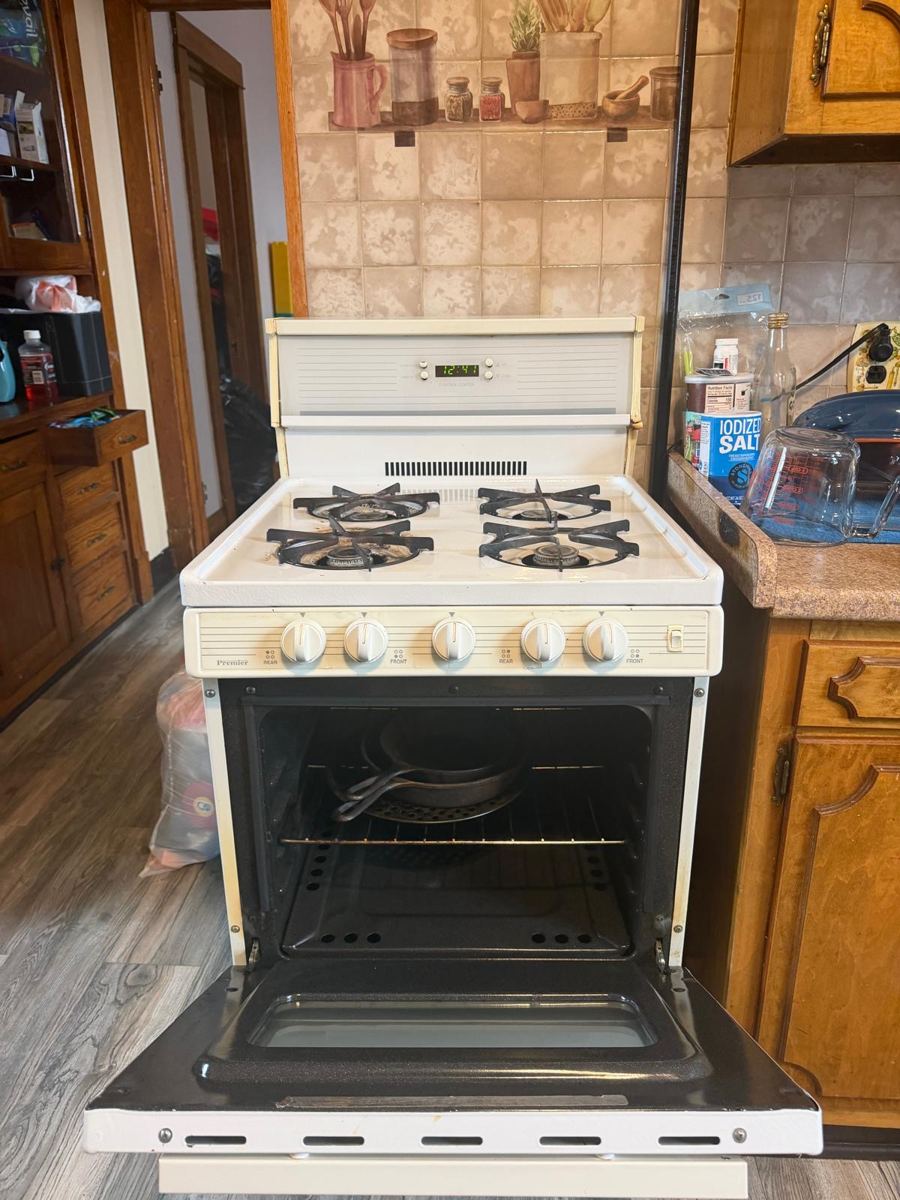 The same kitchen with a clean stove and clear floor