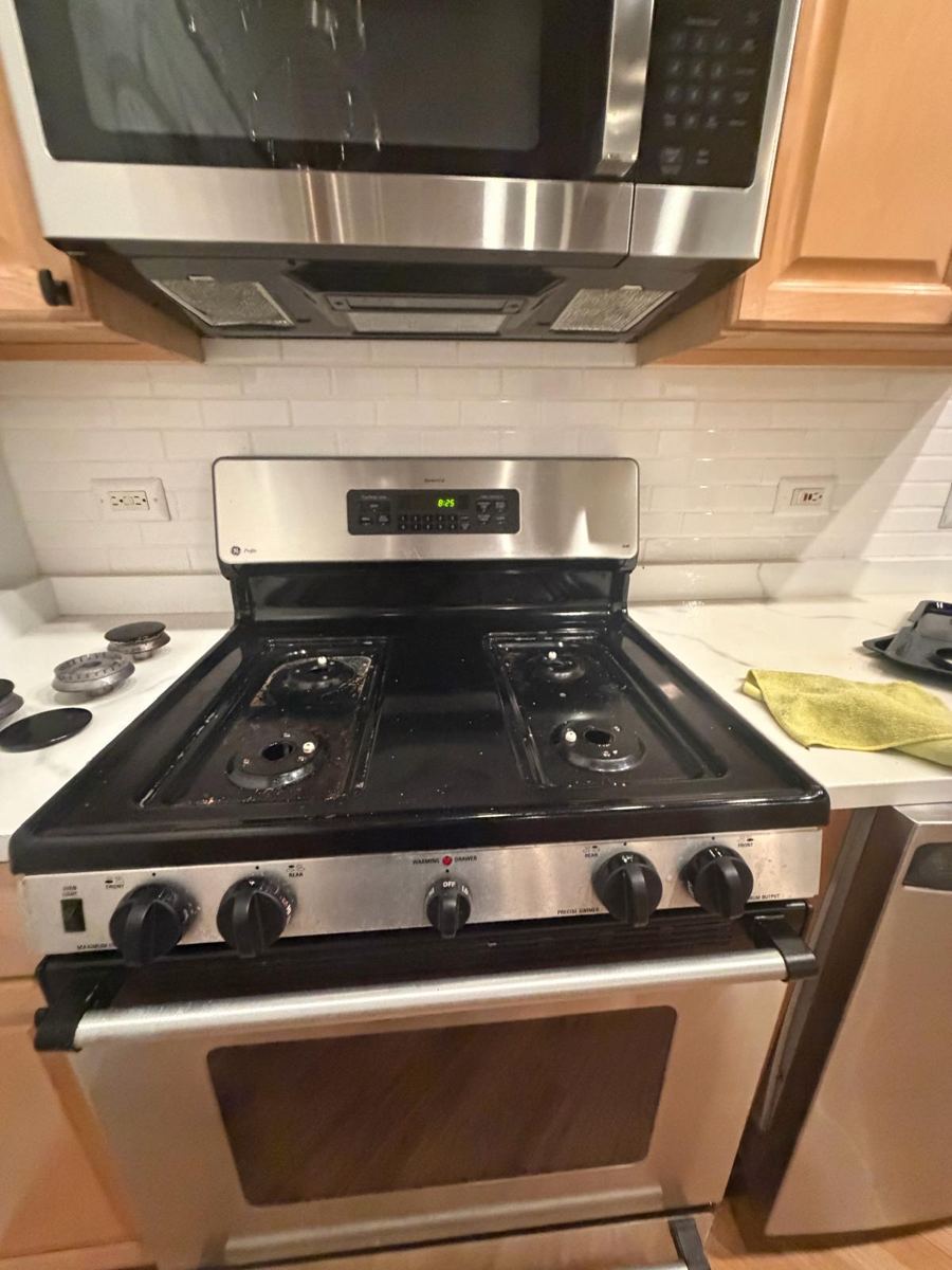 Black stovetop with grime around the burners